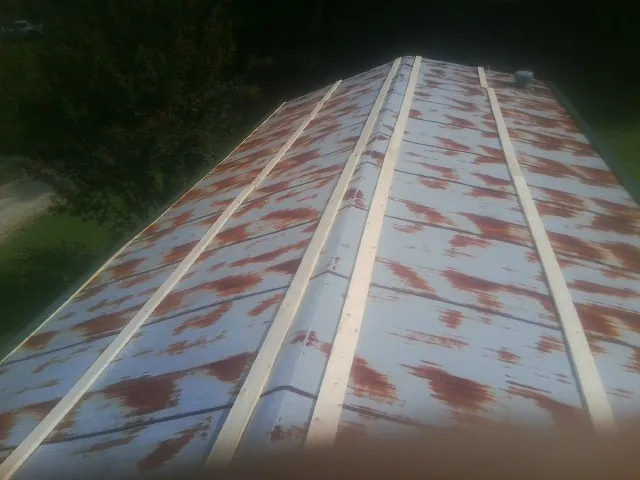 Rusted metal roof panels with new wood purlins before replacement — Storm Damage Roof Repair in Winona Lake by Roofing Brothers